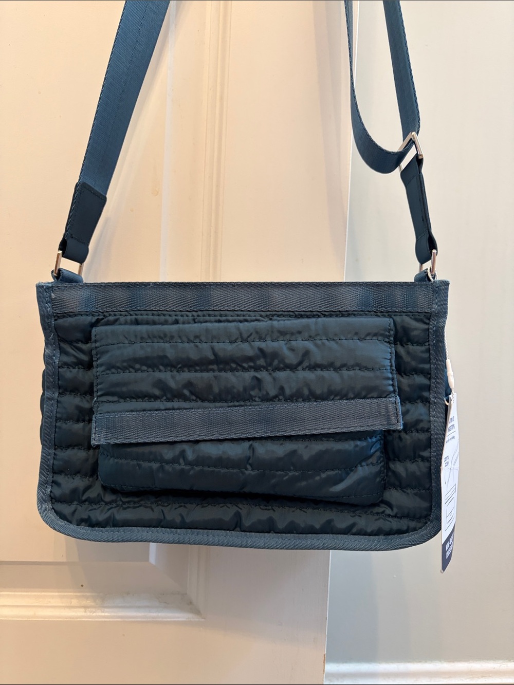 Blue quilted nylon crossbody bag